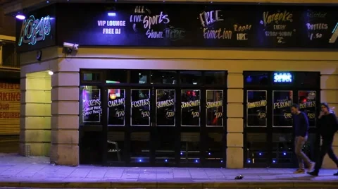 Group of Men Walk Past Pub at Night HD Stock Footage 42188306