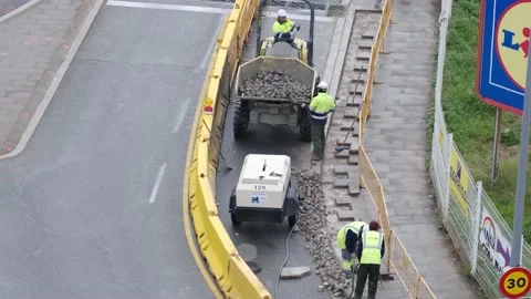 Group of men workers industrial machinery paving the road  in the public street Stock Footage 172542887