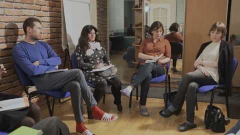 Group of middle-aged people write in a notebook at a conference Stock Footage 88331193