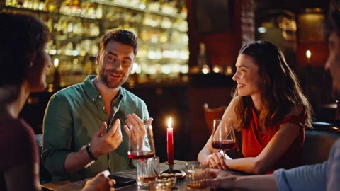 Group millennials gathering bar at weekend evening closeup. Smiling friends Stock Footage 334009038