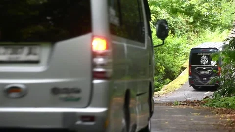Group of Mini Bus convoy doing convoy on the middle of the forest road Stock Footage 327583459
