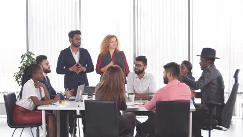 Group of mixed-race diverse co-workers discussing new project in office. Stock Footage 103013126