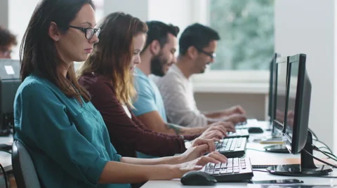Group of Mixed Race Students are sitting in a Row in Computer Class and Working Video stock 67202842