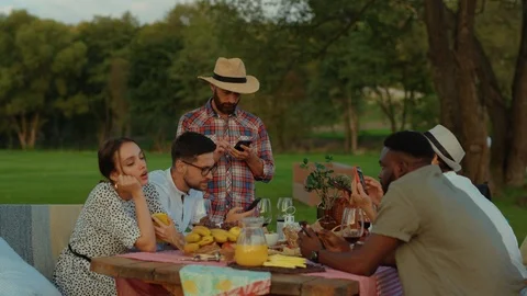 Group of modern friends at dinner table sitting bored and upset using Stock Footage 117257545