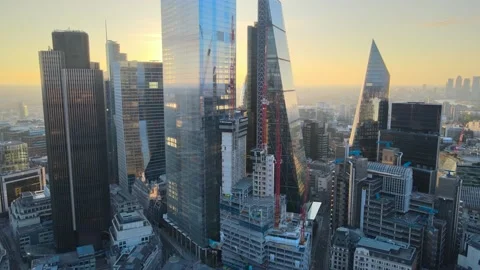 Group of modern glossy skyscrapers in City against golden sunrise sky Stock-Footage 157447622