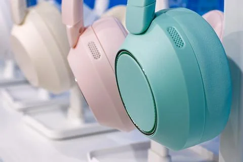 Group of modern multi-coloured wireless headphones. Stock Photos