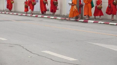 A group of monks are walking down the street Stock Footage 289321712