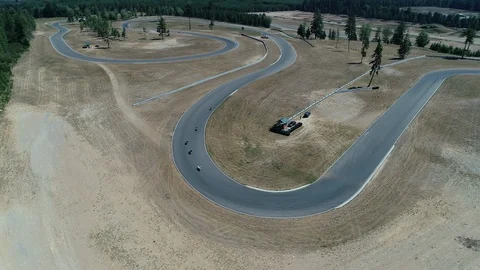 Group of motorcycles come around a sharp turn Stock Footage 126739692