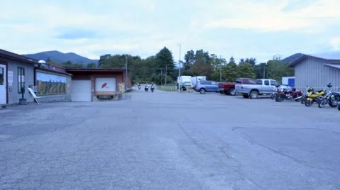 Group of Motorcycles Pulling into Parking Lot Stock Footage 46645778