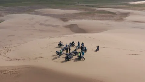 Group of motorcycles on a sand dune in remote western Mongolia. Stock Footage