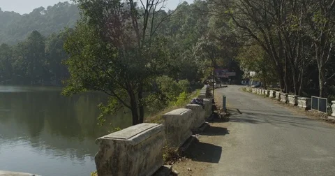 A group of motorcyclists cross a small bridge in Northern India Stock Footage 72990470