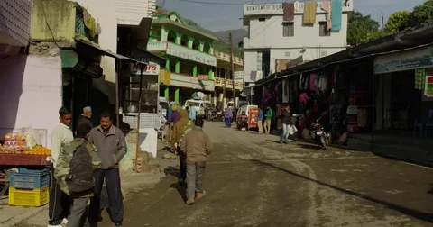 A group of motorcyclists pass a Small hillside village in Northern India, Kumaon Stock Footage 72987810