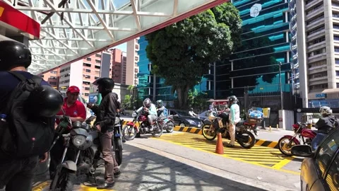 Group of motorcyclists queuing for fuel at a PDV gas station in Los Palos Stock Footage 327468006