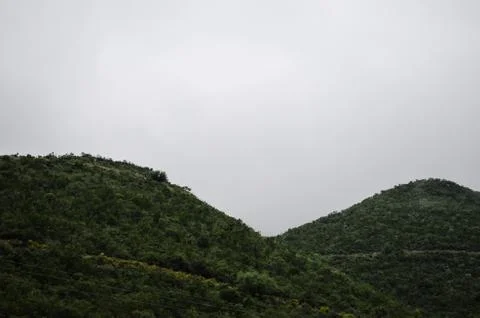 Group of mountains surrounded by haze. Stock Photos