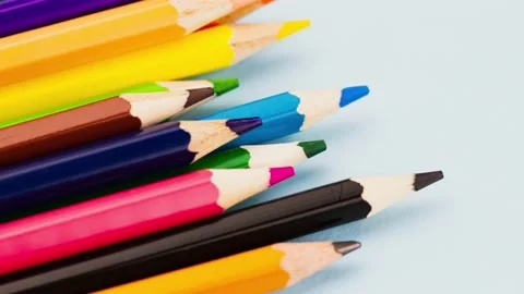 A group of multi-colored colored pencils lie on a gray background close-up, slow Stock Footage 157260582