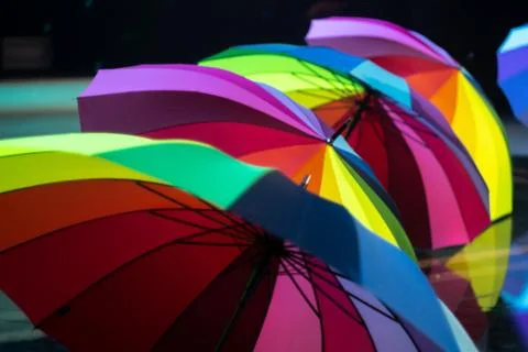 A group of multi-colored umbrellas on stage during a concert. Stock Photos