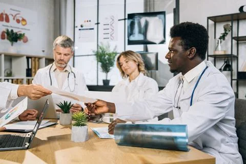 Group of multi ethnic doctors having international training Stock Photos
