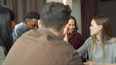 Group of multi-ethnic friends drinking beer and chatting during a meeting Stock Footage 124039681