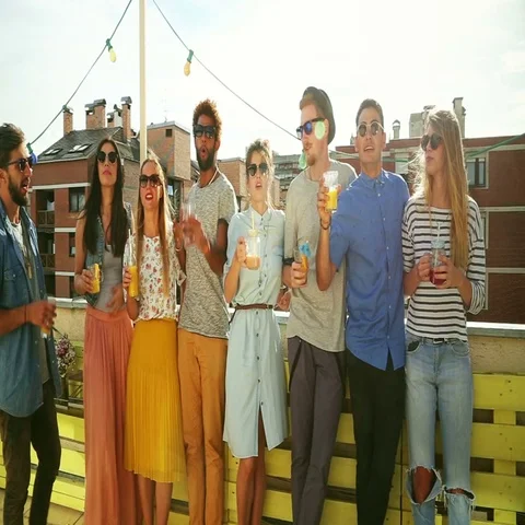 Group of multi-ethnic friends standing at rooftop and toasting Stock Footage 69301604