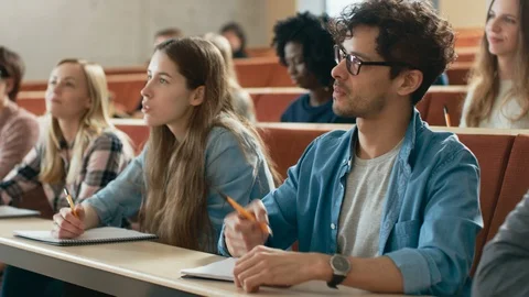 Group of Multi Ethnic Students in Classroom Listening  Lecture and Taking Notes. Stock Footage 87967223