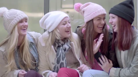 Group Of Multi-Ethnic Teens Sit On A Bench They Chat And Laugh Video stock 46895192