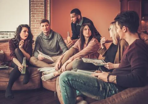 Group of multi ethnic young students preparing for exams in home interior Stock Photos