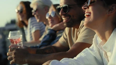 Group of multi ethnicity friends talking together at the party in top of the roo Stock Footage 203954493