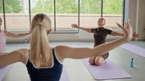 Group of Multi-generational Women Practicing Yoga in Studio Stock Footage 339864654