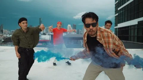 Group of multicultural hipster playing color flare at rooftop. Hiphop. Stock Photos