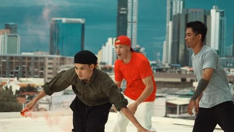 Group of multicultural hipster playing color flare at rooftop. Hiphop. Stock Photos