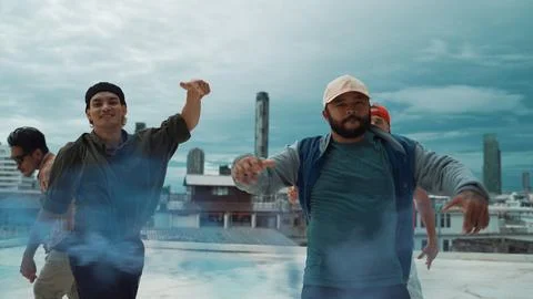 Group of multicultural hipster playing color flare at rooftop. Hiphop. Stock Photos