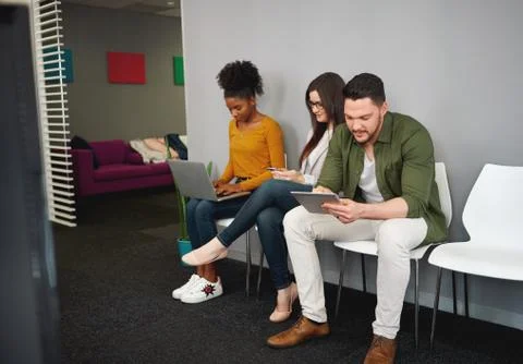 Group of multicultural young people sitting in row on chair for job interview Stock Photos