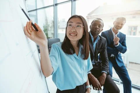 Group of multiethnic business people working together on project while sitting Stock Photos