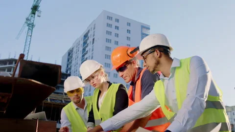 Group multiethnic of engineers and architects they using a plan of building to Stock Footage 146605758