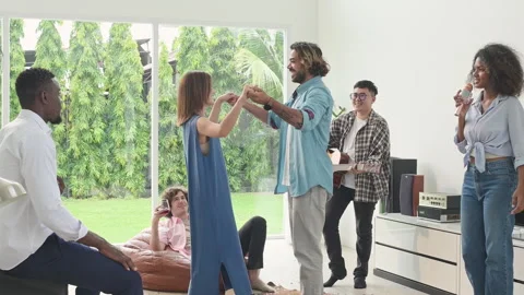 Group of multiethnic friends having fun at party by playing guitar and singing Video stock 253994871