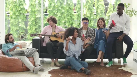 Group of multiethnic friends having fun at party by playing guitar and singing 스톡 동영상 253995430