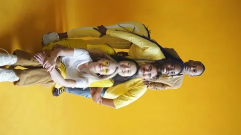 Group of multiethnic friends, people of different cultures isolated on yellow Stock Footage 144425892