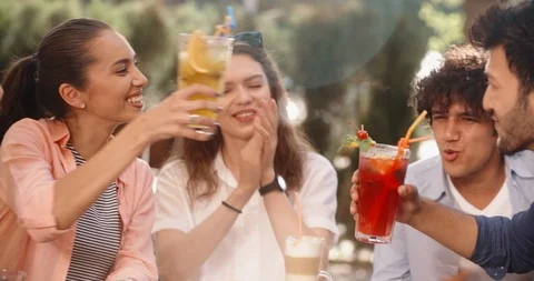 Group of multiethnic friends sitting at table in cafe outdoors, chatting Video stock 95927736