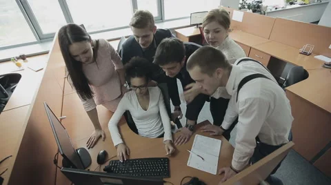 Group of multiethnic office workers around colleague using computer Stock Footage 57244571