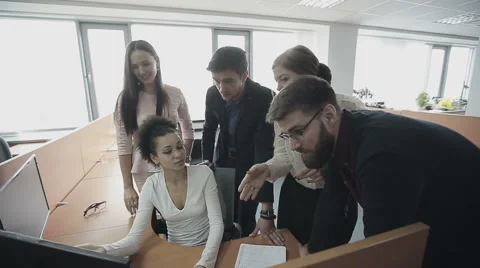 Group of multiethnic office workers around colleague using computer. Slow motion Stock Footage 57244665