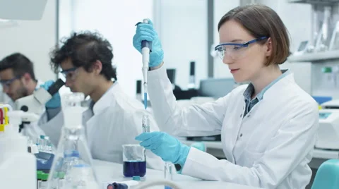 Group of Multiethnic Students in Coats Working in Laboratory Stock Footage 62951653