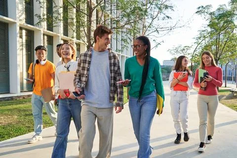 Group of multiethnic students walking going to classroom at university. Stock Photos