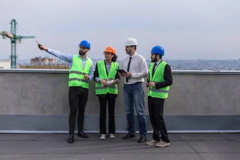 A group of multiethnic workers at construction site engineer architects and Stock Photos