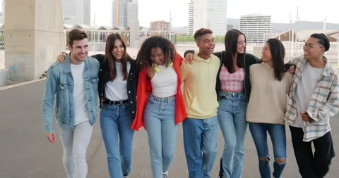 Group of multiethnic young friends walking through the city laughing Stock Footage 230284339