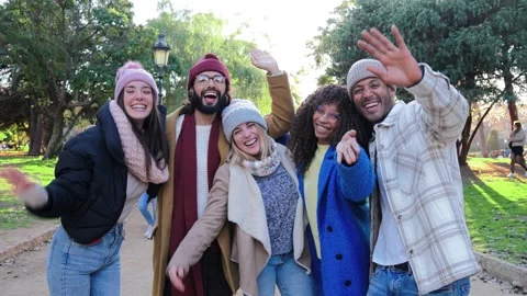 Group of multiethnic young people smiling and waving hands. Front view of Stock Footage 235960360