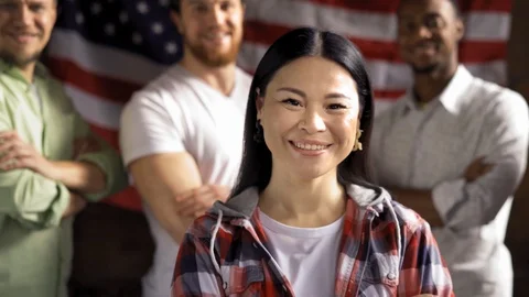 Group of multiethnical immigrands standing happy posing on american flag. Stock Footage 126245604