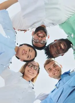 GROUP OF MULTINATIONAL INTERNS LOOKING DOWN Smiling Stock Photos