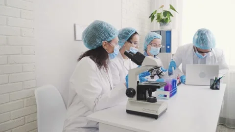 A group of multinational laboratory technicians, an african american female Stock Footage 230637983