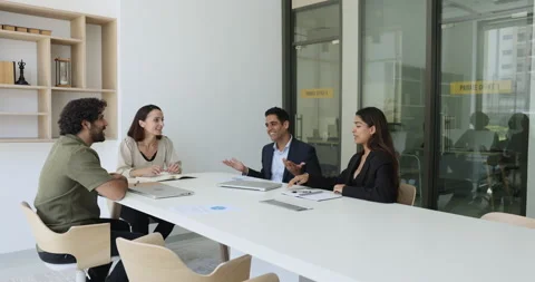 Group of multinational staff communicate during meeting in boardroom Stock Footage 243656511