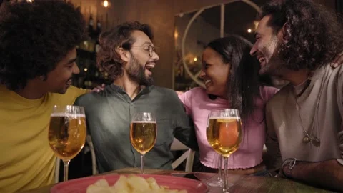 Group multiracial colleagues gathered chatting happily restaurant bar after work Stock Footage 234112731